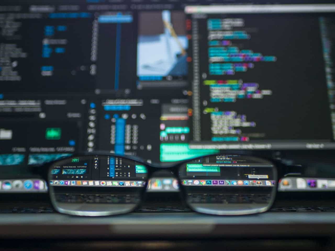 glasses with code in the background related to web development
